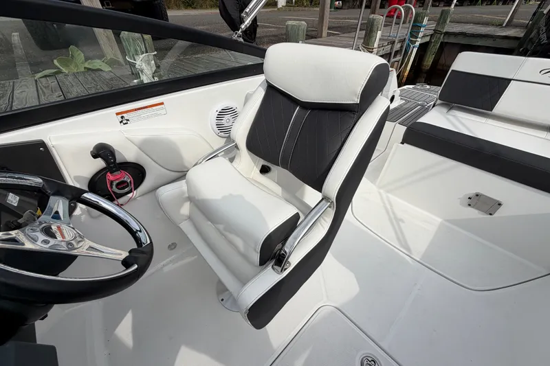 Slide: The Image of Interior of a 2021 Monterey M-45 boat featuring a sleek captain's chair and steering wheel. - 25