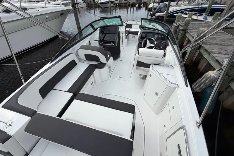 Slide: The Image of 2021 Monterey M-45 boat interior with sleek seating and modern dashboard at a marina. - 14