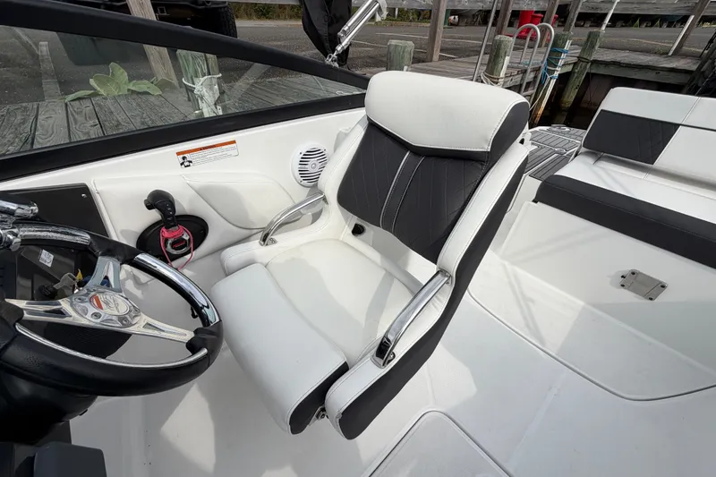 Slide: The Image of Interior of a 2021 Monterey M-45 boat featuring a sleek captain's chair and steering wheel. - 26