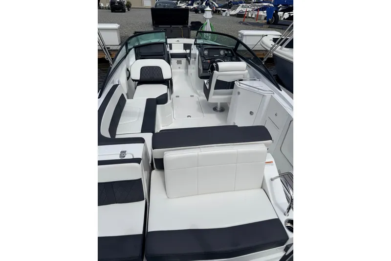 Slide: The Image of 2021 Monterey M-45 boat interior with sleek white and black seating, docked at a marina. - 4