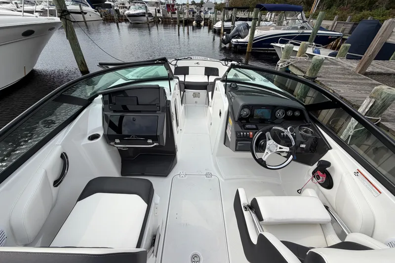 Slide: The Image of 2021 Monterey M-45 boat interior at a marina, featuring sleek seating and modern dashboard. - 28