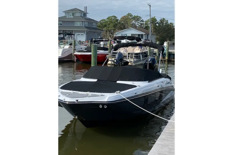 Slide: The Image of 2021 Monterey M-45 boat docked at a marina, featuring sleek design and black cover. - 0
