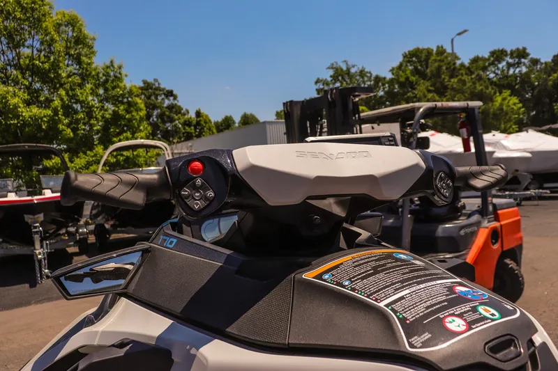 Slide: The Image of 2026 Sea-Doo FishPro Sport 170 handlebars and controls, outdoor display setting. - 9