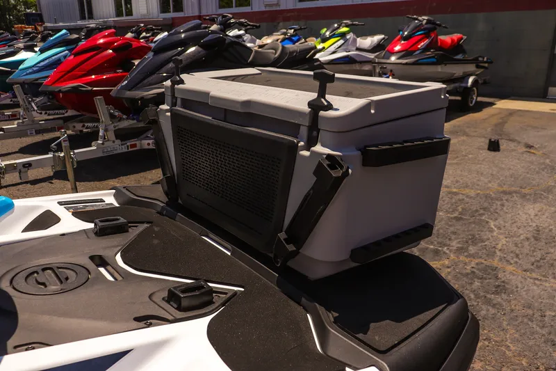 Slide: The Image of 2026 Sea-Doo FishPro Sport 170 with cooler, parked among colorful jet skis. - 10