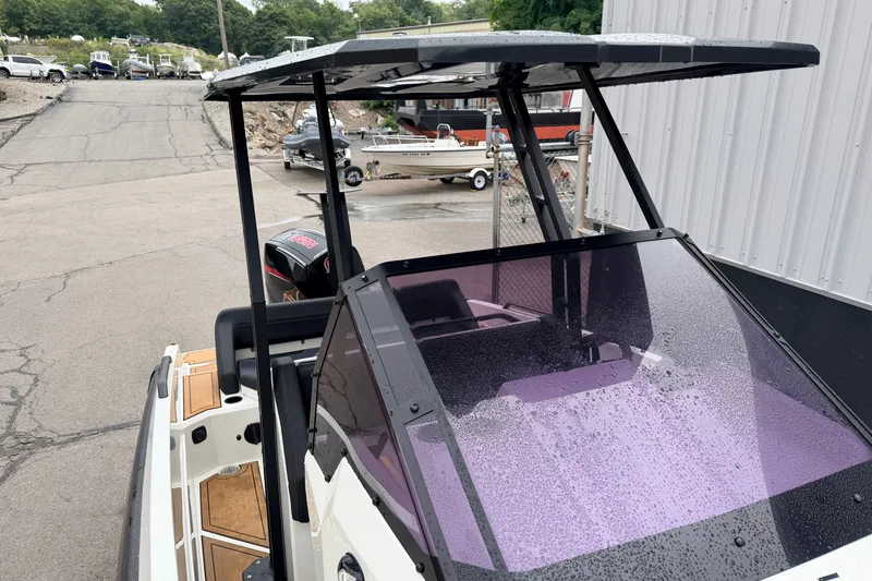 Slide: The Image of 2024 Iron 707 boat with wet windshield, parked near other boats. - 17