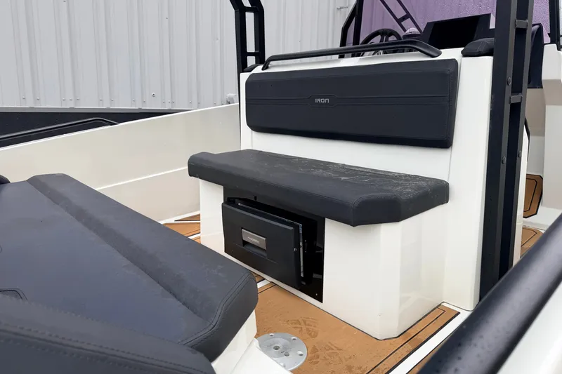 Slide: The Image of 2024 Iron 707 boat interior with black cushioned seating and modern design. - 13