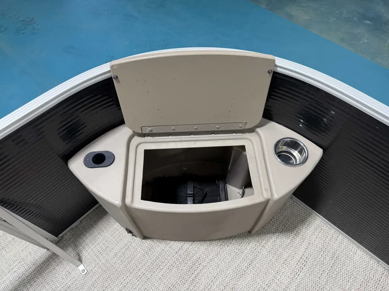 Slide: The Image of The image shows the bow of a 2020 Bennington 22SFXAPG with a built-in storage compartment and cup holder. - 21