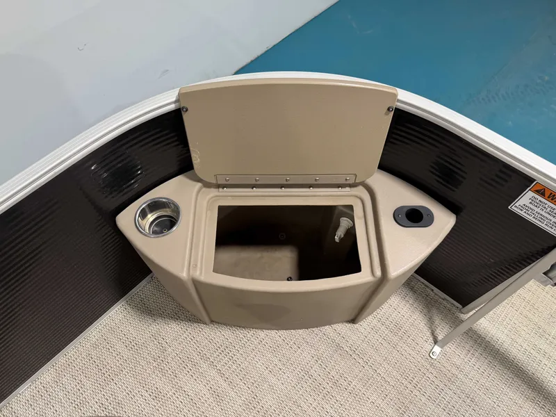 Slide: The Image of The image shows part of a 2020 Bennington 22SFXAPG boat. There's a built-in compartment with a cup holder and small storage space. - 20