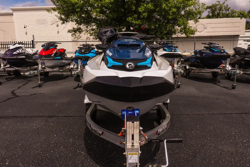 Slide: The Image of 2026 Sea-Doo FishPro Sport 170 jet skis displayed on trailers in a parking lot. - 2