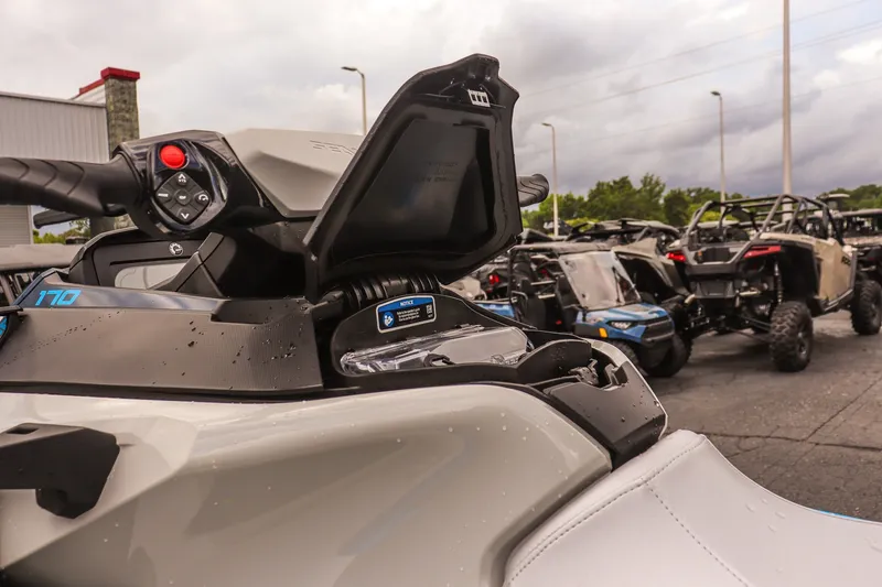 Slide: The Image of 2026 Sea-Doo FishPro Sport 170 jet ski with open storage compartment, parked outdoors. - 15