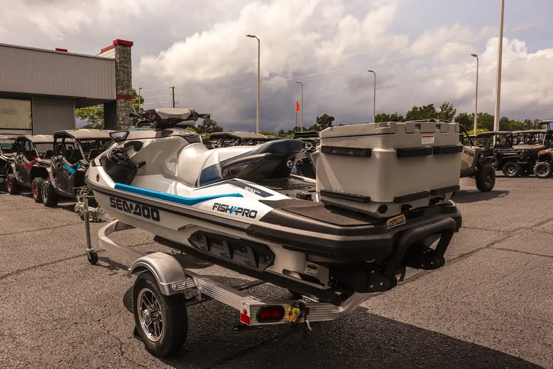 Slide: The Image of 2026 Sea-Doo FishPro Sport 170 on trailer, parked outdoors with cloudy sky backdrop. - 7