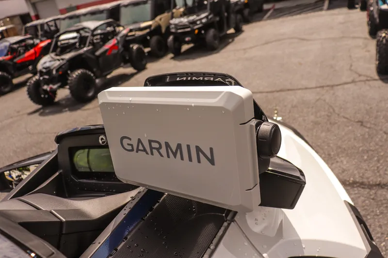 Slide: The Image of 2026 Sea-Doo FishPro Sport 170 with Garmin navigation system, parked among off-road vehicles. - 11