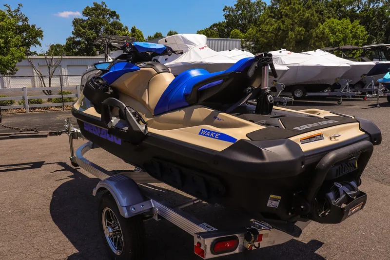 Slide: The Image of 2026 Sea-Doo Wake 170 jet ski on trailer, parked outdoors under clear sky. - 5