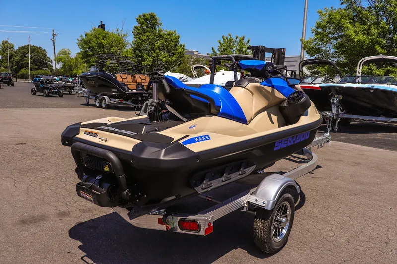 Slide: The Image of 2026 Sea-Doo Wake 170 jet ski on trailer, parked outdoors in a lot. - 3