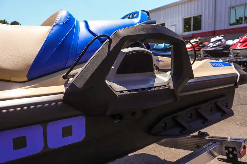 Slide: The Image of 2026 Sea-Doo Wake 170 jet ski, featuring blue and beige seating, parked outdoors. - 9