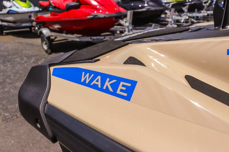 Slide: The Image of 2026 Sea-Doo Wake 170 jet ski close-up with vibrant colors in a showroom. - 15
