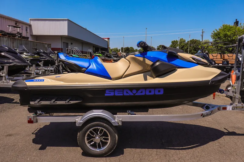 Slide: The Image of 2026 Sea-Doo Wake 170 jet ski on trailer, beige and blue design, outdoor display. - 2