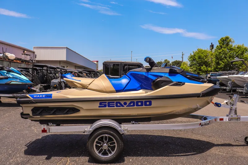 Slide: The Image of 2026 Sea-Doo Wake Pro 230 jet ski on trailer, parked outdoors. - 2