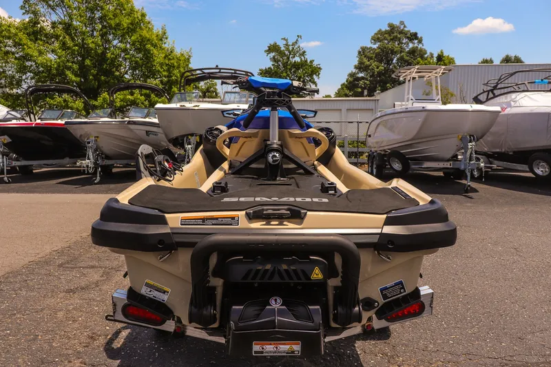 Slide: The Image of 2026 Sea-Doo Wake Pro 230 jet ski displayed in a boat dealership lot. - 4