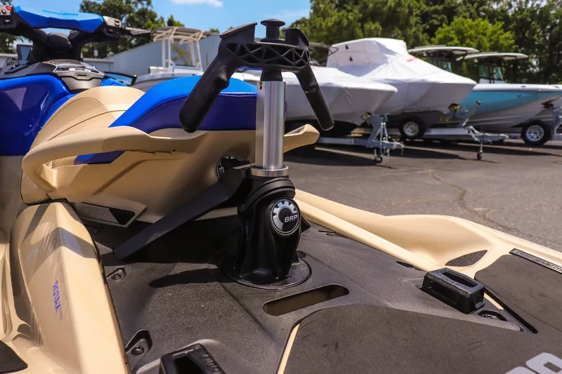 Slide: The Image of 2026 Sea-Doo Wake Pro 230 jet ski with blue and beige design, parked outdoors. - 11