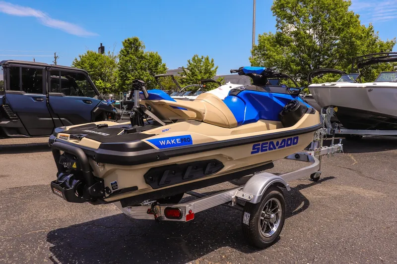 Slide: The Image of 2026 Sea-Doo Wake Pro 230 jet ski on trailer, parked outdoors. - 3