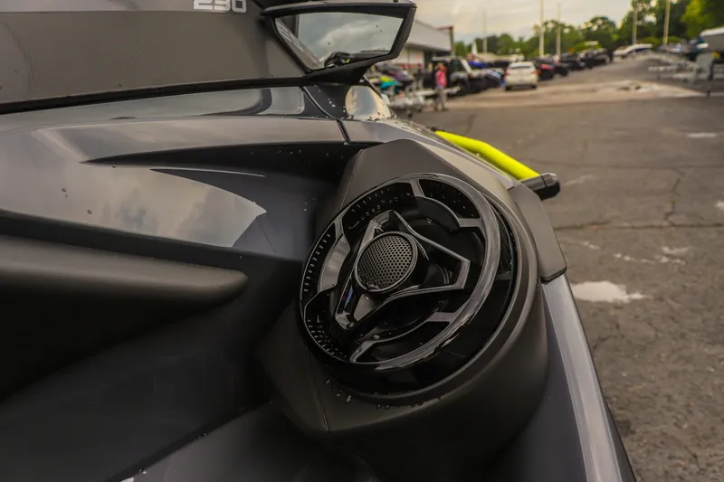 Slide: The Image of Close-up of 2026 Sea-Doo Explorer Pro 230 speaker detail in a parking lot. - 15