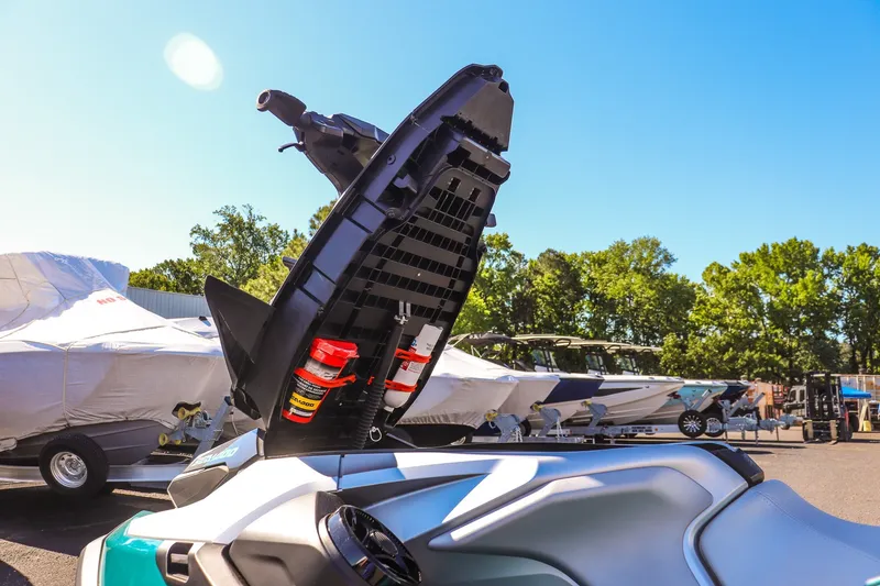 Slide: The Image of 2026 Sea-Doo GTX Limited 325 with open storage compartment, parked outdoors. - 14