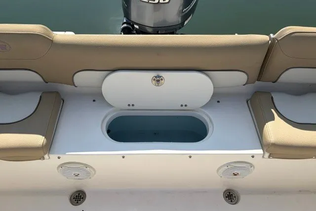 Slide: The Image of 2019 Key West 239 FS boat interior with tan seating and storage compartment. - 13