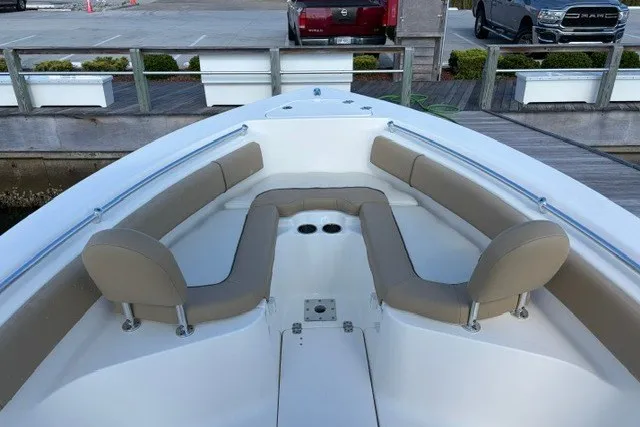 Slide: The Image of 2019 Key West 239 FS boat with spacious seating and cup holders at the bow. - 8