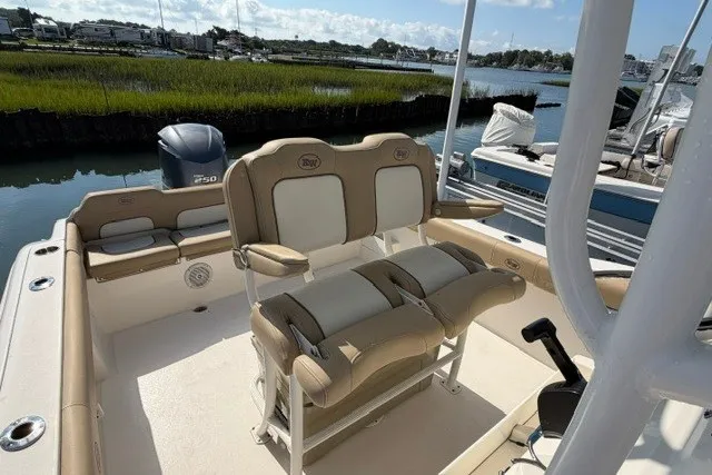 Slide: The Image of 2019 Key West 239 FS boat interior with seating, docked by a scenic waterway. - 18