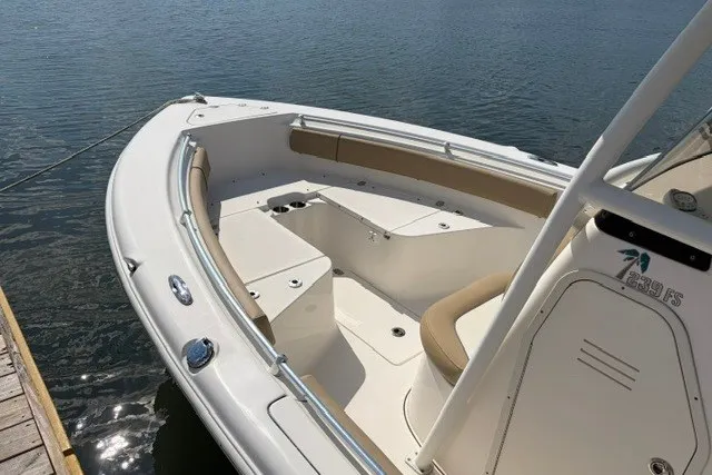 Slide: The Image of 2019 Key West 239 FS boat docked, featuring spacious seating and sleek design. - 4