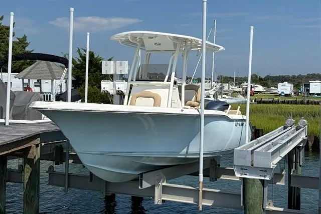 The Image of 2019 Key West 239 FS boat docked on a lift in a marina. - 0