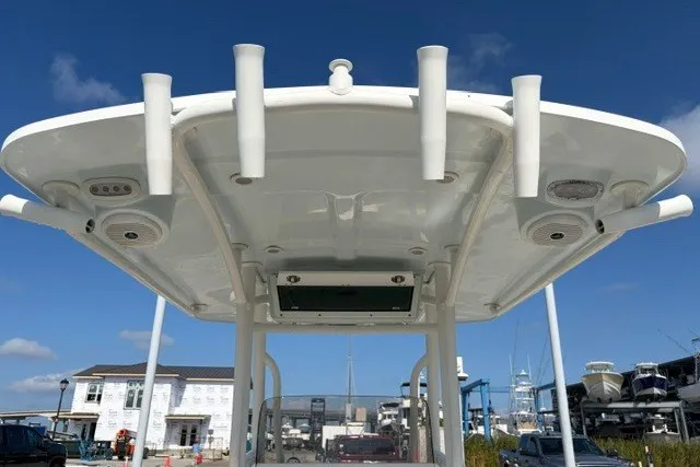 Slide: The Image of 2019 Key West 239 FS boat with rod holders and T-top, docked at a marina. - 25