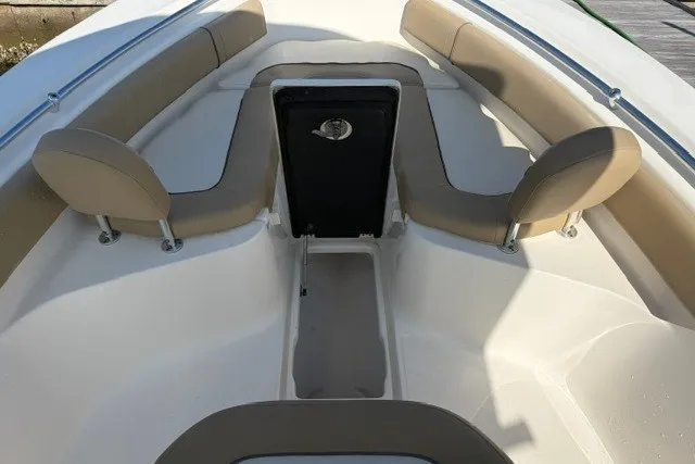 Slide: The Image of 2019 Key West 239 FS boat interior with beige seating and storage compartment. - 11