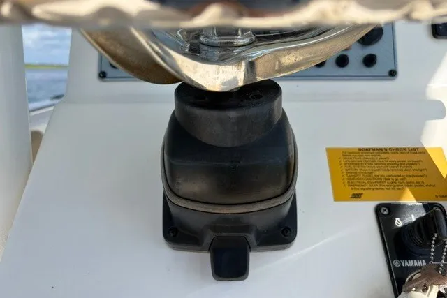 Slide: The Image of 2019 Key West 239 FS boat dashboard with steering wheel and controls. - 23