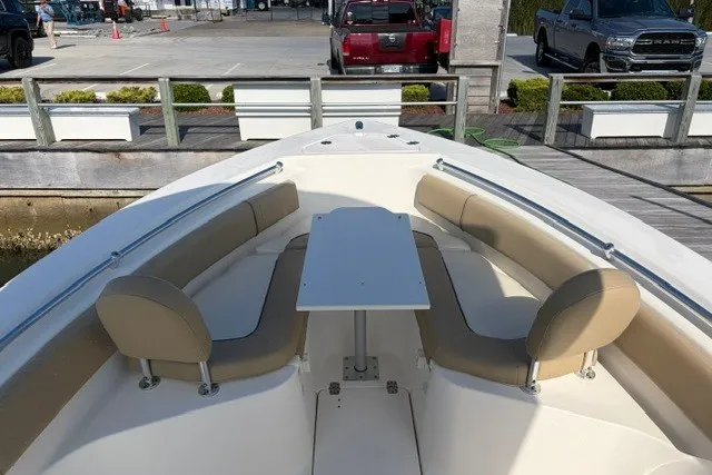 Slide: The Image of 2019 Key West 239 FS boat with spacious seating and table on deck. - 10