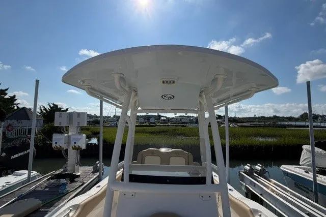 Slide: The Image of 2019 Key West 239 FS boat docked, featuring a T-top and scenic waterfront view. - 24