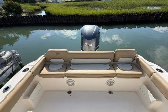 Slide: The Image of 2019 Key West 239 FS boat with Yamaha 250 engine, docked by a serene waterway. - 12