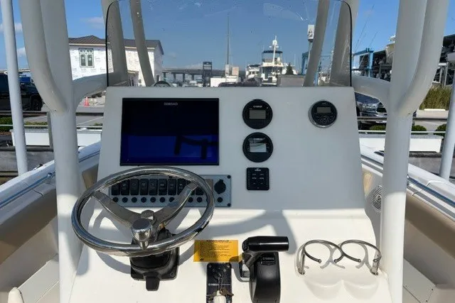 Slide: The Image of 2019 Key West 239 FS boat dashboard with steering wheel and navigation controls. - 20
