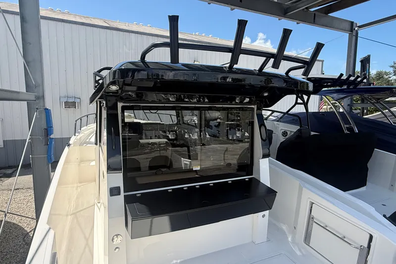 Slide: The Image of 2026 Navan C30 boat with sleek design and modern features, docked outdoors. - 14