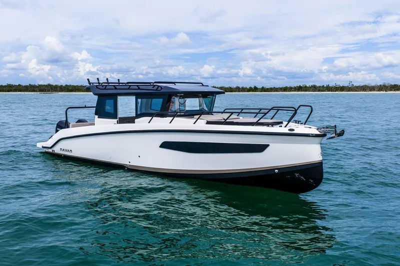 Slide: The Image of 2026 Navan C30 boat cruising on clear blue water under a partly cloudy sky. - 4