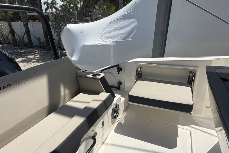 Slide: The Image of Interior seating of 2026 Navan C30 boat, featuring cushioned benches and cup holders. - 13
