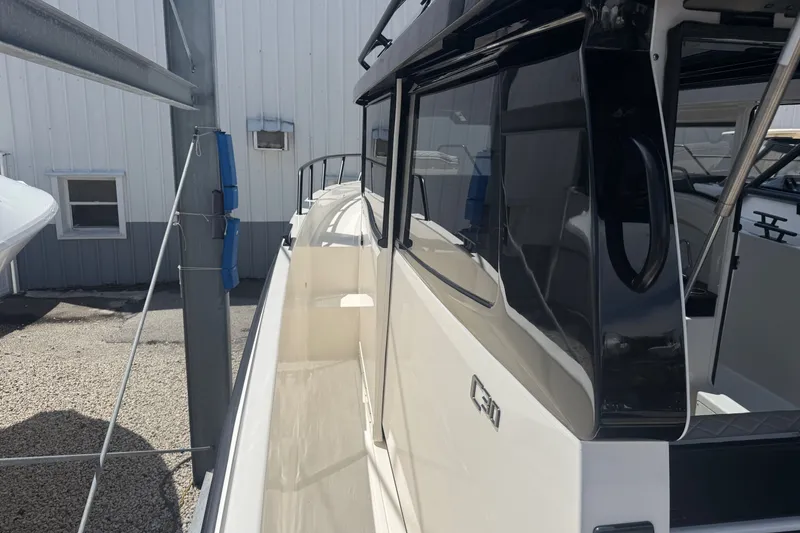 Slide: The Image of 2026 Navan C30 boat side view, docked near a white building. - 17