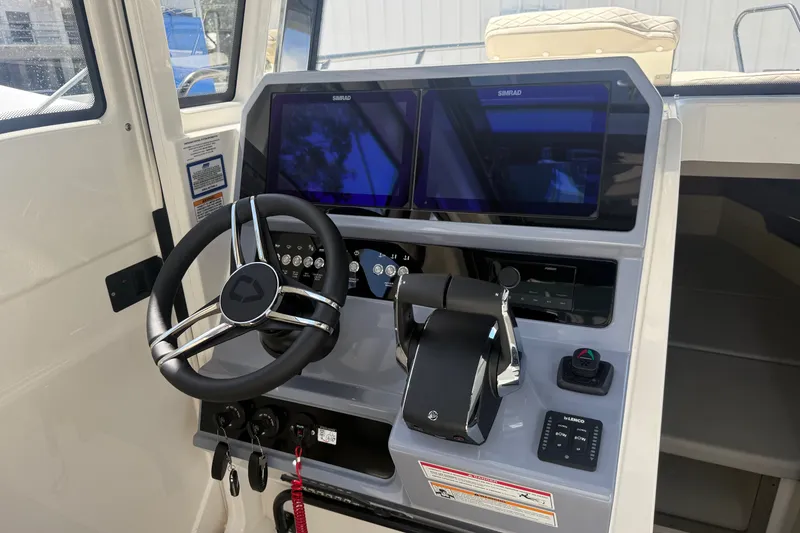 Slide: The Image of Helm of 2026 Navan C30 boat with dual Simrad displays and modern controls. - 24
