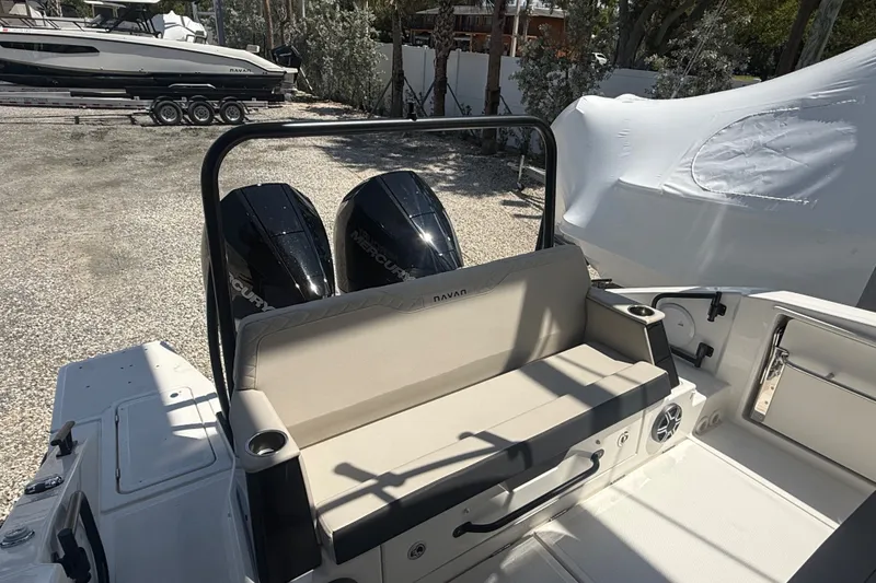 Slide: The Image of 2026 Navan C30 boat with dual Mercury engines and comfortable seating in a sunny marina. - 12