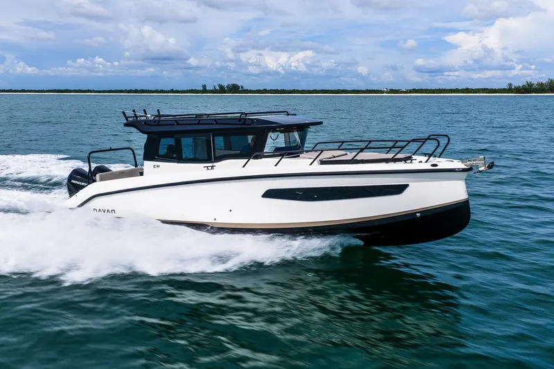 Slide: The Image of 2026 Navan C30 boat cruising on open water under a partly cloudy sky. - 9