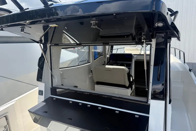Slide: The Image of 2026 Navan C30 boat interior with open rear window and seating area. - 21