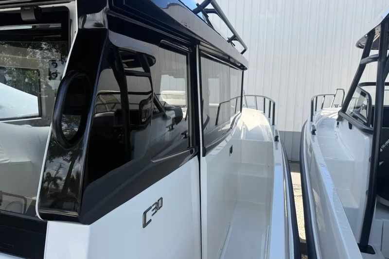 Slide: The Image of 2026 Navan C30 boat, sleek design with black and white exterior, docked side by side. - 16