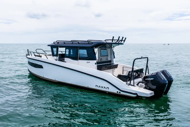 Slide: The Image of 2026 Navan C30 boat on calm sea with dual Mercury engines. - 2