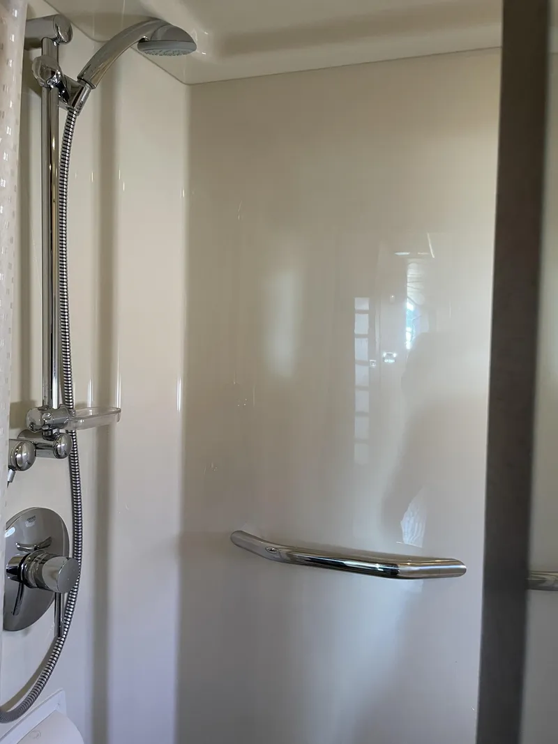 Slide: The Image of A shower stall with chrome showerhead and handle in a boat bathroom. - 45